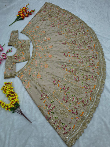 Ravishing Beige and Orange Crape Silk Embroidered Lehenga