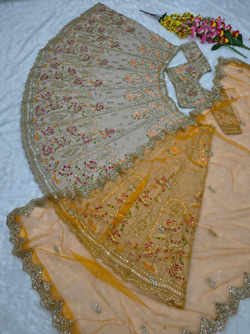 Ravishing Beige and Orange Crape Silk Embroidered Lehenga