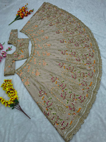 Ravishing Beige and Orange Crape Silk Embroidered Lehenga