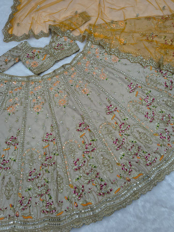 Ravishing Beige and Orange Crape Silk Embroidered Lehenga